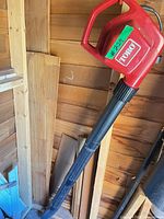 Full view of Toro red blower with black nozzle standing vertically