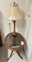 Side table with lamp on top, showing size tags