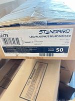 Label on 50-count box showing model, wattage, colour temperature, voltage, base and quantity