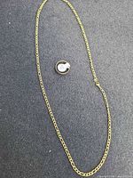 Necklace full length alongside ring to show both items