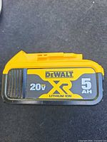 Front view of DeWALT XR 20V 5Ah battery showing branding and specs