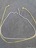 Both chains laid flat showing full length and clasp ends