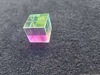Full view of cube showing iridescent faces and internal grid