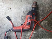 Full view of Jobmate corded drill showing body, cord, rusted chuck