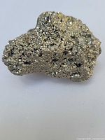 Front view of metallic gold pyrite druzy cluster showing crystal texture