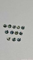 11 round multicolour sapphires on neutral background