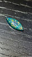Top view of marquise black opal showing multicolour flashes