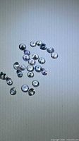 Loose round tanzanite stones spread on surface