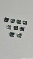 Nine square princess-cut sapphires arranged in three rows