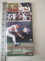 Front cover showing player fielding, title and price