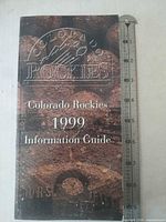 Front cover with embossed logo and ruler showing height