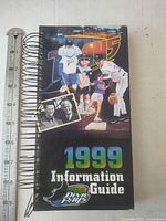 Front cover of spiral-bound 1999 Tampa Bay Devil Rays Information Guide beside ruler