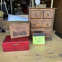 All three boxes on table: wooden mini dresser, Cal Neva souvenir box, red faux-leather box