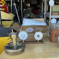Overall lot with weather station, brass ashtray with compass, and glass mug