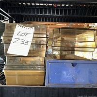 Stack of amber lucite cases with blue metal drawers below