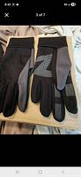 Pair of black and gray gloves laid flat showing exterior