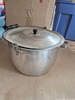 Full view of aluminum stock pot with lid and handles