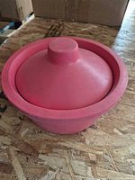 Top view of red silicone bowl with domed lid fitted