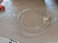 Top view of clear pressed glass tray showing full radial pattern and both handles