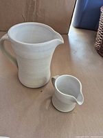 Large stoneware pitcher and small matching creamer front view