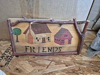 Front of plaque showing painted design and twig frame
