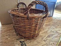 Side view of wicker basket showing shape and handles