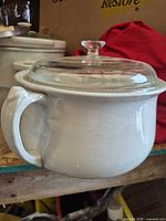 Side view of white ironstone chamber pot with glass lid in place