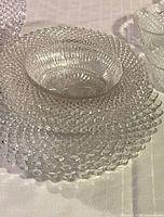 Stack of three hobnail plates with ribbed dessert bowl on top