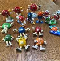 Group shot of all 14 M&M's figurines and magnets on table