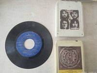 Front view of 7" single and two 8-track cartridges