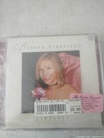 Front of sealed jewel case displaying album cover and retail stickers