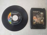 Front of 45 RPM single and 8-track cartridge