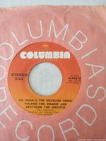 Side showing "Roland The Roadie and Gertrude The Groupie" on orange Columbia label