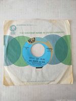 Record in MGM sleeve showing Spill The Wine label