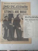 Front view of entire folded newspaper showing headline and photo