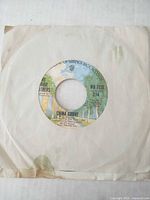 Front of paper sleeve with record inside showing center label "China Grove"