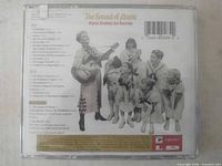 Back of jewel case with track list, UPC 074646058329, cast photo