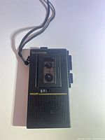 Front view of Philips Micro Two MCR-7002 recorder showing speaker grille, cassette window and wrist strap