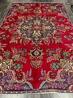 Full view of Persian Tabriz rug showing design and colors