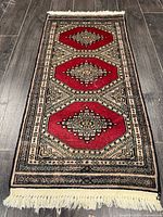 Full view of Turkman rug showing entire design and fringe