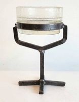 Front view of candle holder with glass insert in wrought iron stand