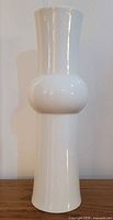 Front view of tall white porcelain vase showing overall shape