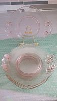 Two plates displayed, one upright on stand showing handle and concentric ring detail