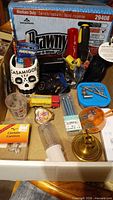 Assorted items including Brawny wipes, skull cup, hand tools, fasteners