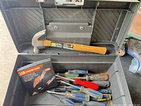 Open Rubbermaid toolbox with hammer, screwdrivers, LED gloves box visible