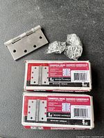Two Tell hinge boxes, one loose hinge, three screw packs