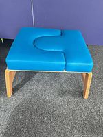 Overall view of blue vinyl yoga inversion bench on carpet