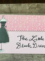 Lid exterior showing Little Black Dress graphic and date