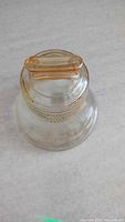 Top view showing amber plastic coin slot cap and glass neck