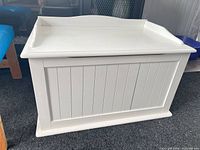 Front view of white beadboard chest closed